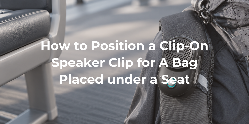 A clip-on speaker on a bag positioned beside an under-seat space.