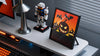 Divoom Pixoo-64, MiniToo and Ditoo-Pro on a Halloween-themed desk with pixel ghost and pumpkin animations, orange ambient lighting