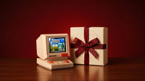 Cream Divoom speaker beside a ribbon-wrapped gift